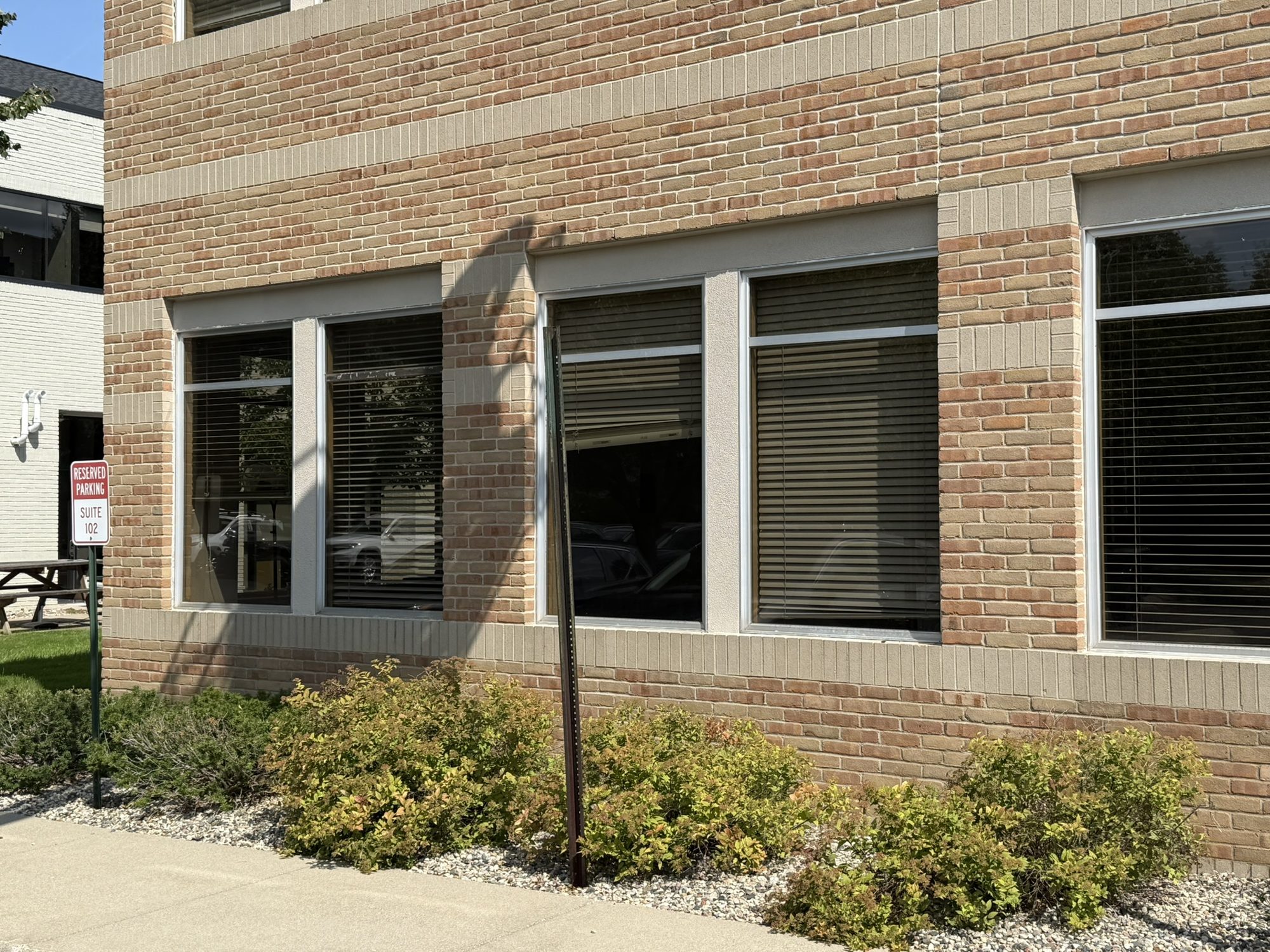 Brick commercial building with new windows and landscaping