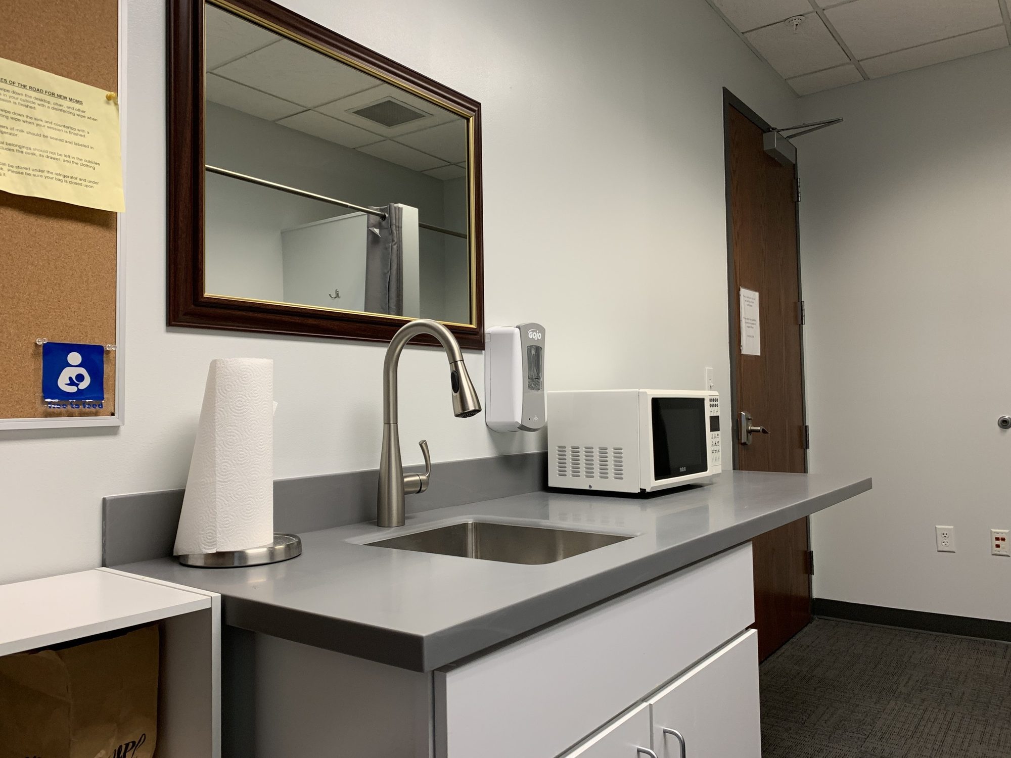 Break room counter and sink with new cabinets and mirror