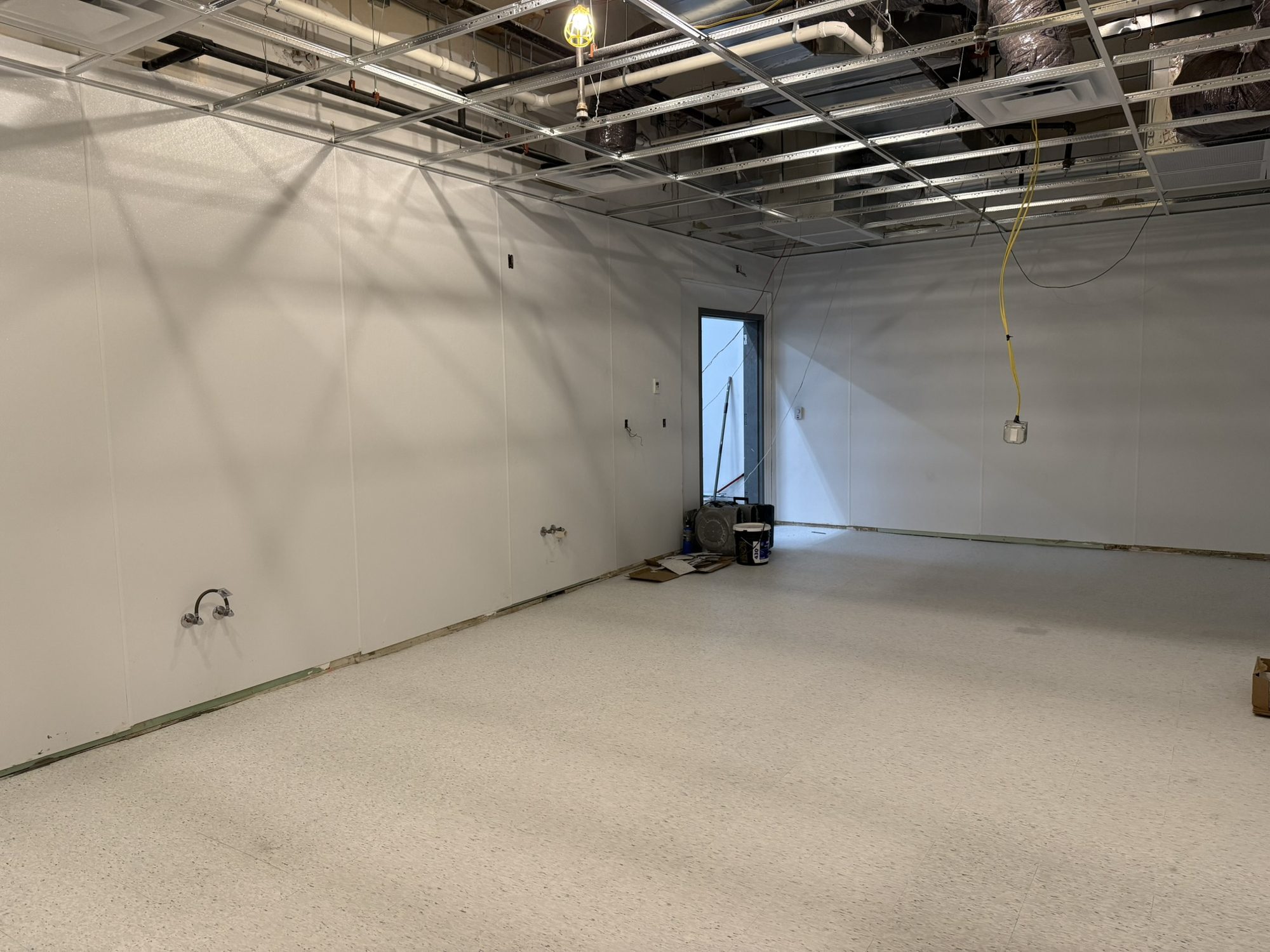 Open kitchen prep room with new white speckled VCT flooring