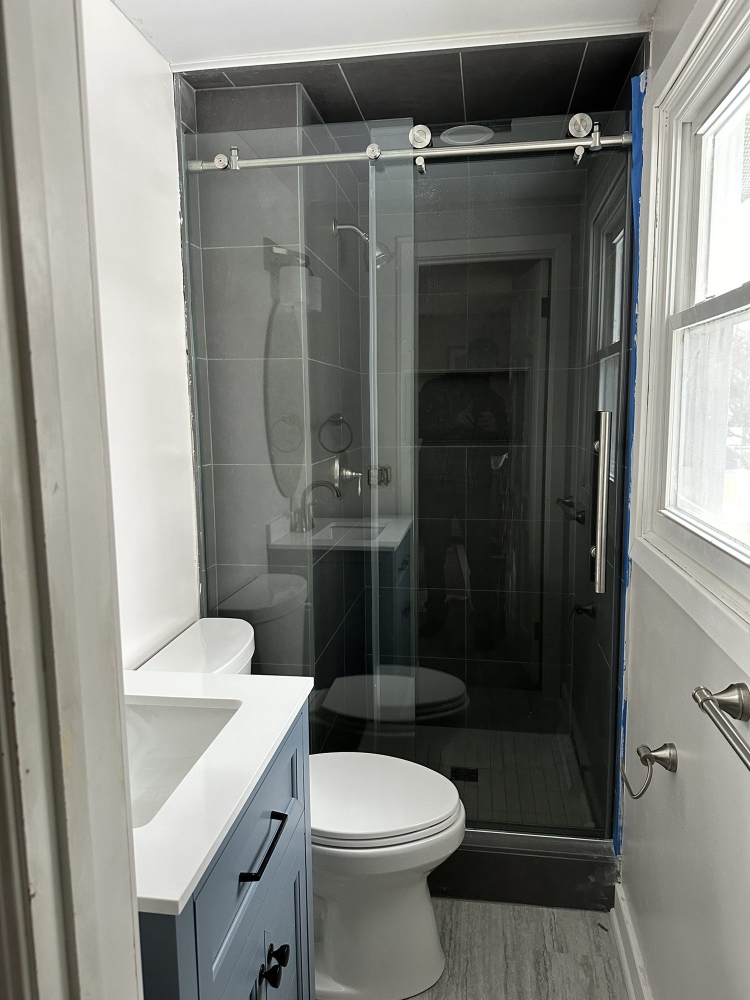 Remodeled bathroom with glass sliding-door shower