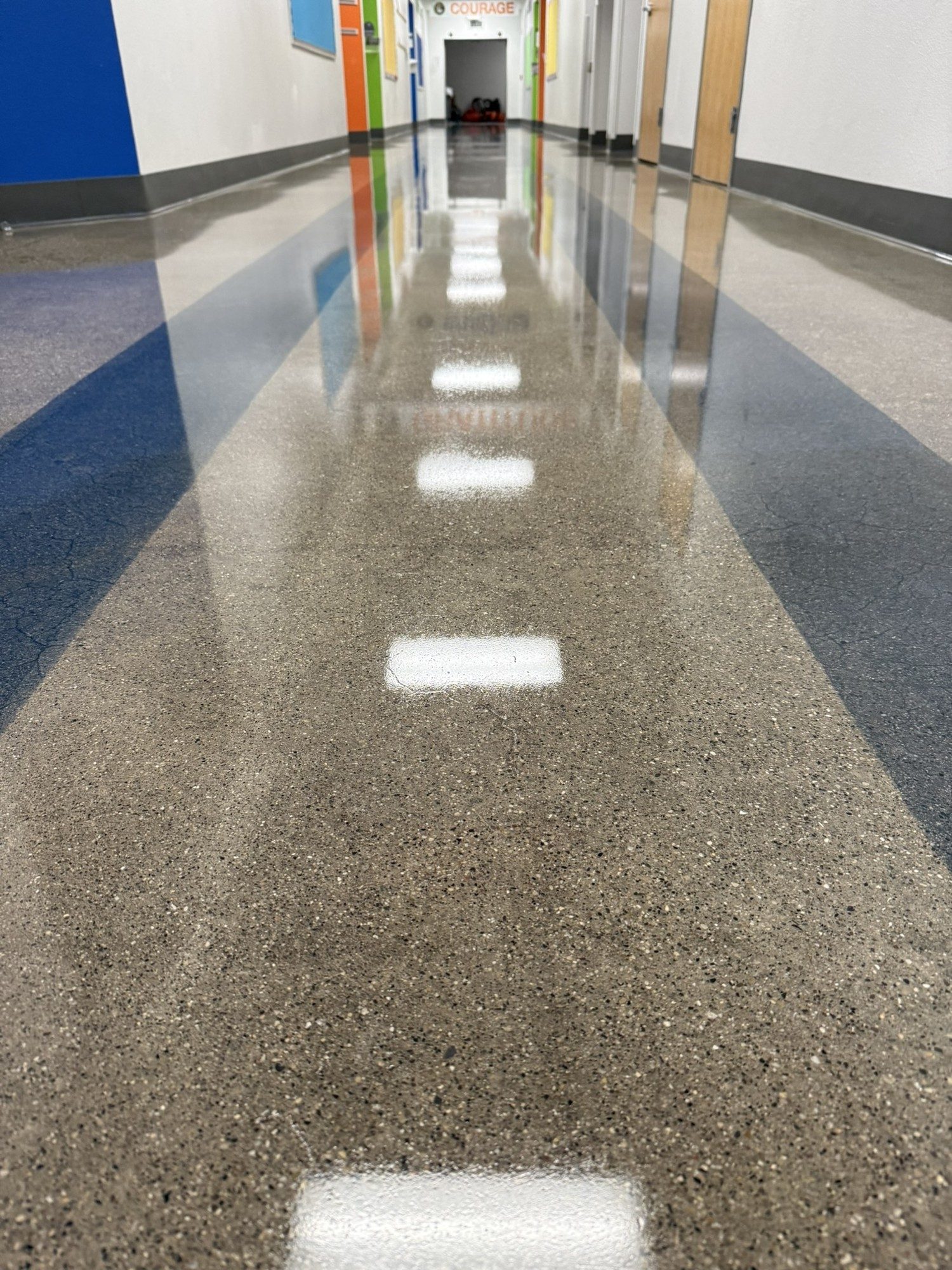 Polished concrete corridor with blue accent stripe